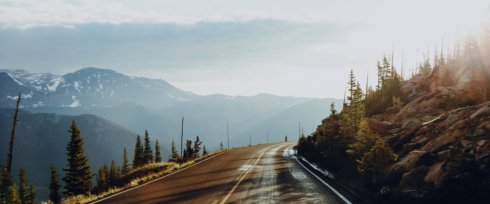 Long view of mountain road with a little snow