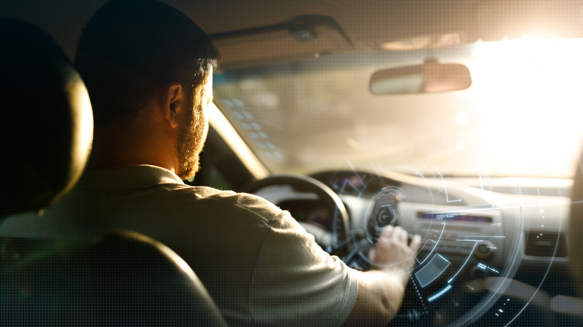 Photo of a person driving into a sunshine-filled sky.